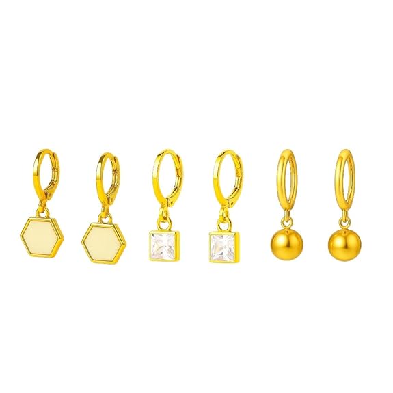 Set of gold earrings with various shapes on a white background