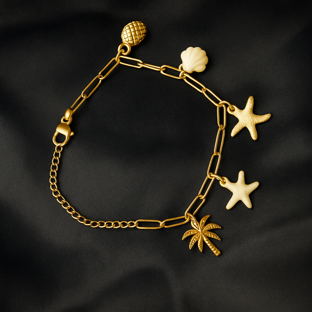 Gold bracelet with starfish, shell, and palm tree charms on a black fabric background