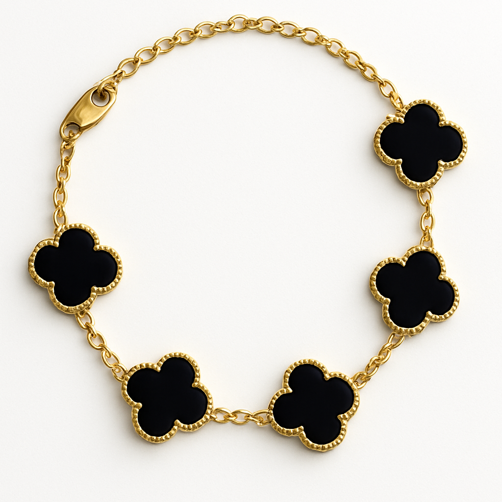 Gold bracelet with black clover-shaped charms on a white background