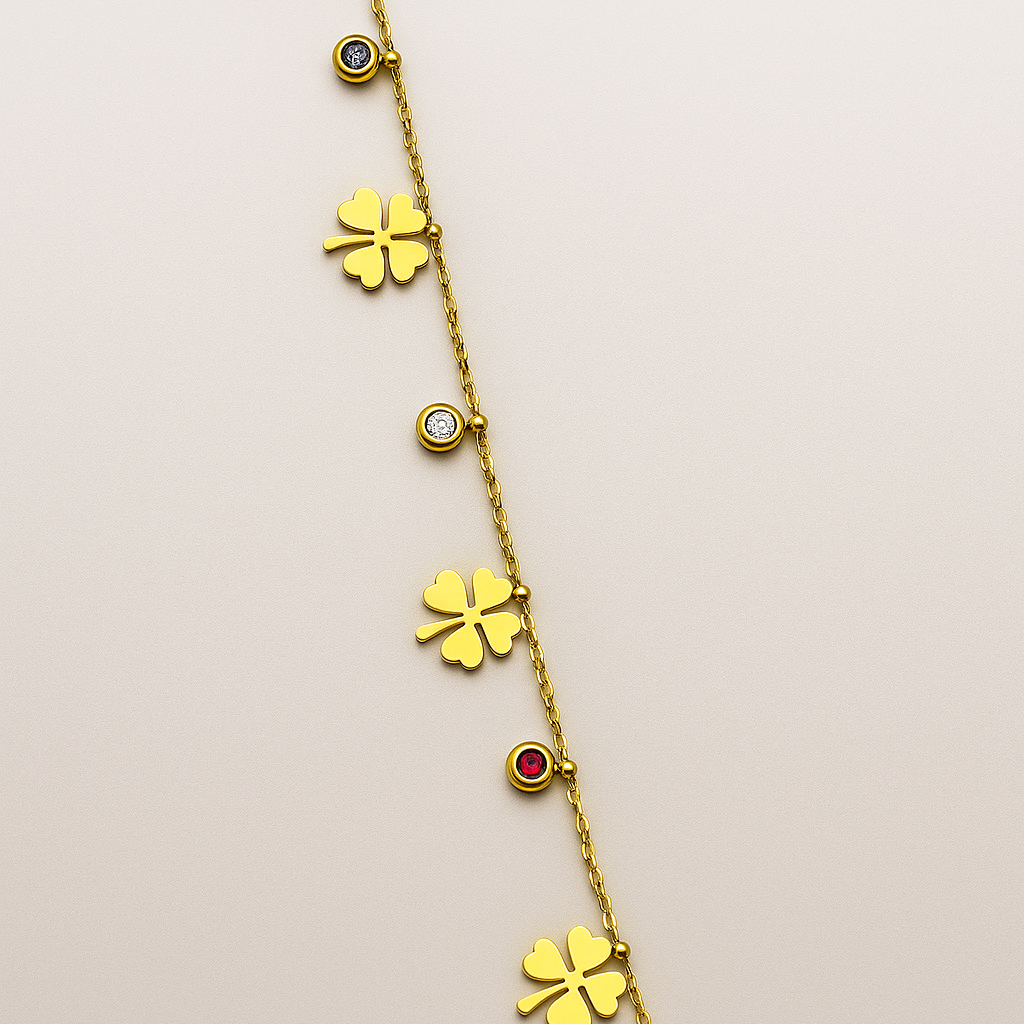 Gold necklace with clover-shaped pendants on a beige background