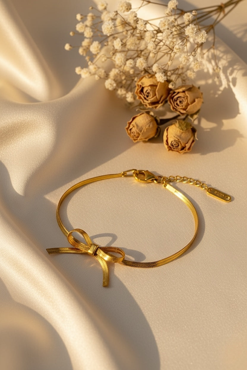Gold bracelet on a beige fabric background with dried roses.